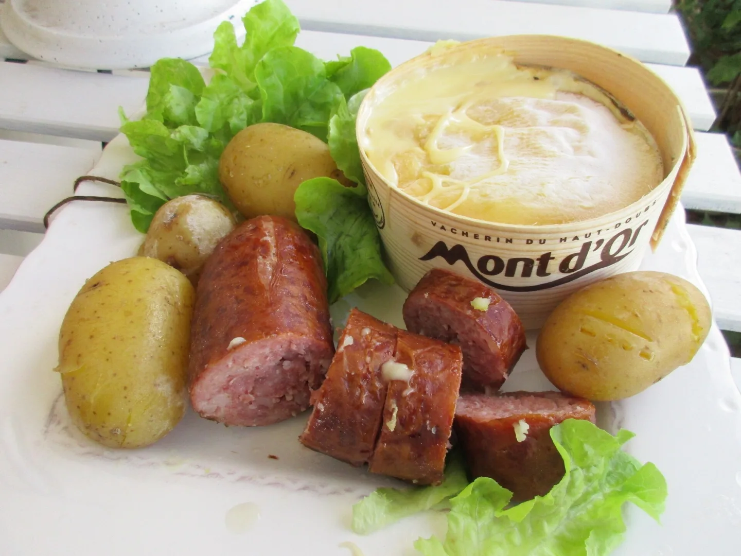 Baked Mont d'Or with potatoes and Morteau sausage.
