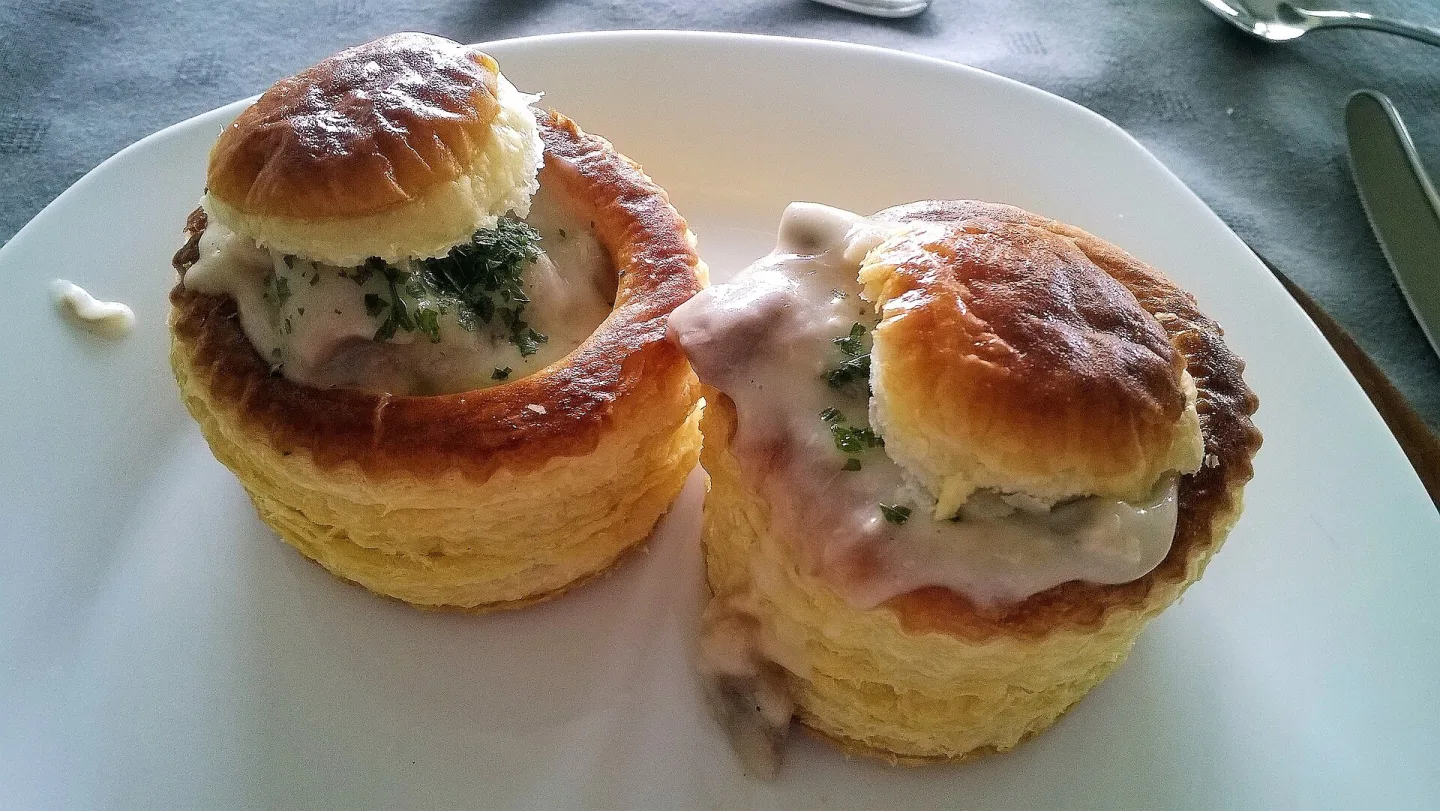 Two puff-pastry bouchees filled with a creamy savory mixture.