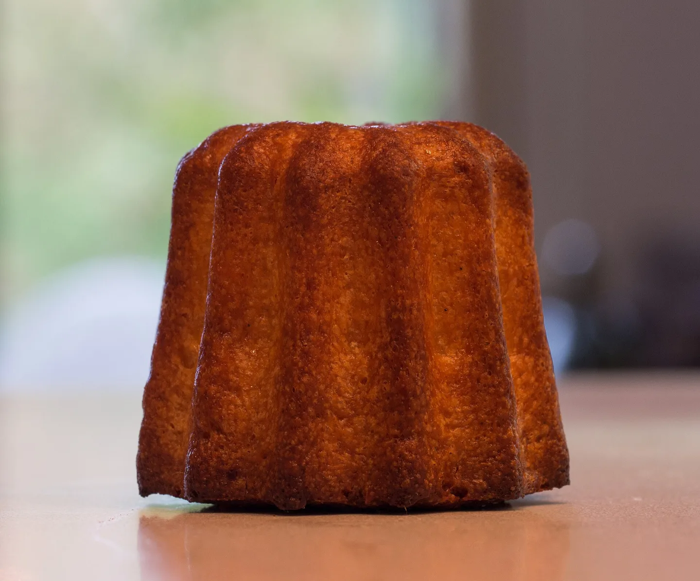 A canelé with a caramelized fluted crust.