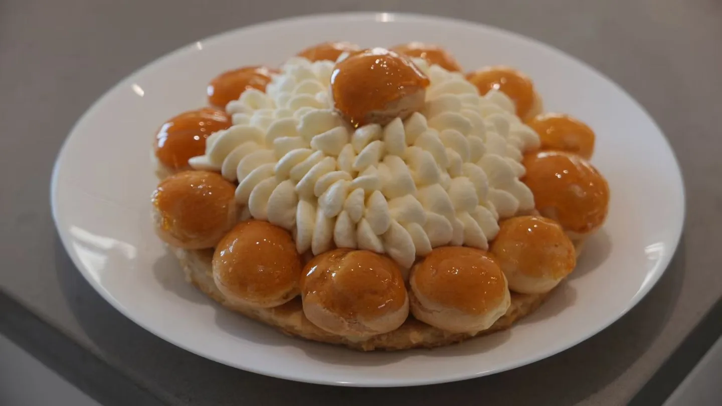 Saint-Honoré with cream and caramel-coated choux puffs.