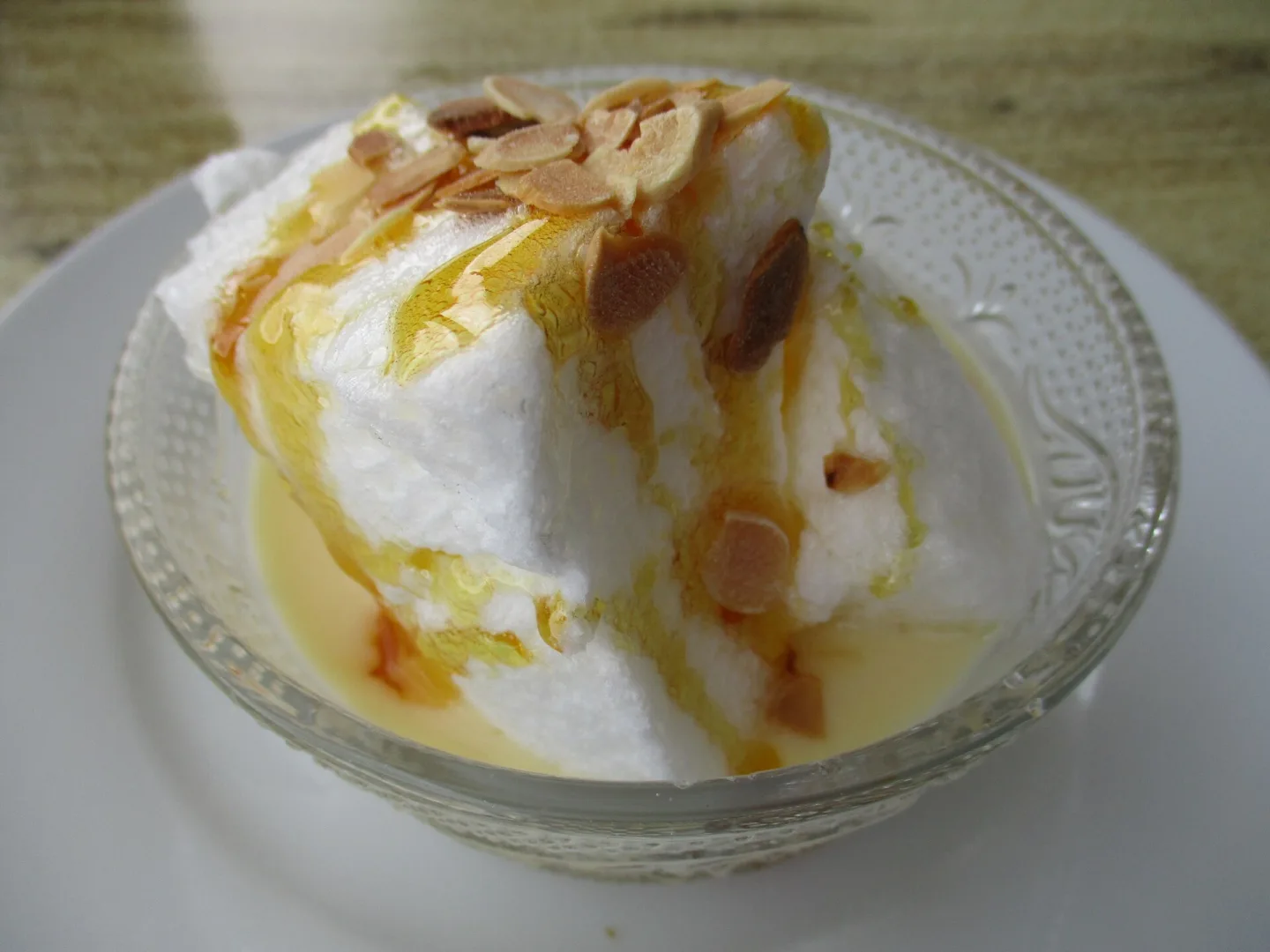 Île flottante with custard, caramel and almond topping.
