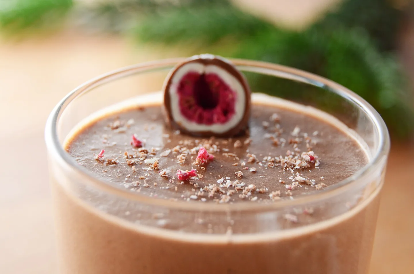 Chocolate mousse in a glass, decorated with a raspberry.