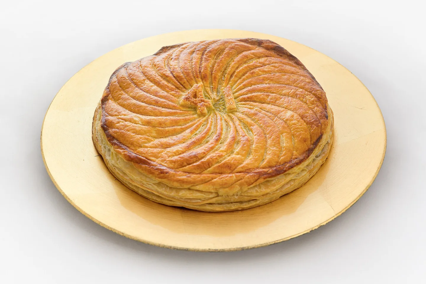 An almond galette des rois with a patterned pastry top.