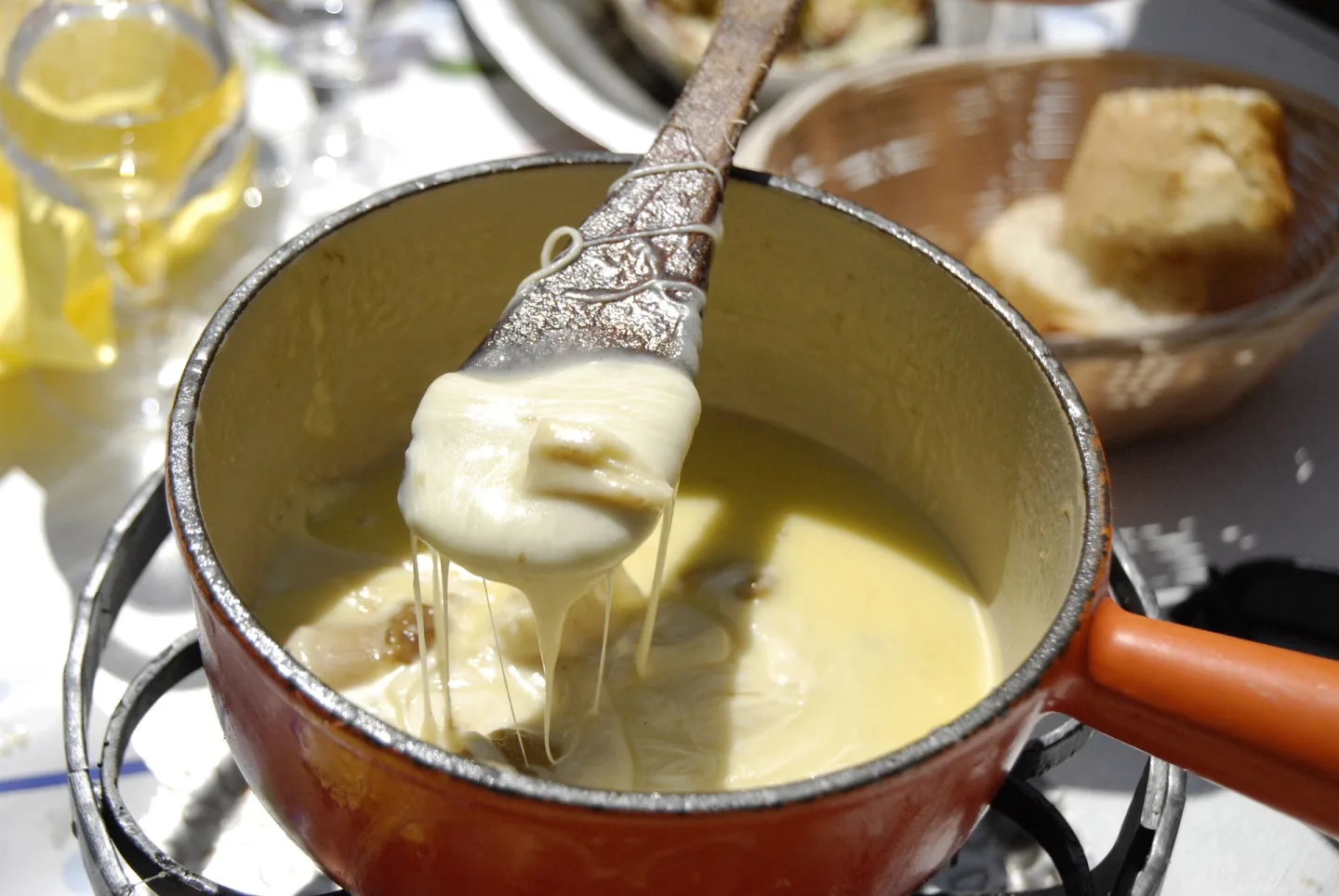 Savoyard cheese fondue with bread dipped into the melted cheese.