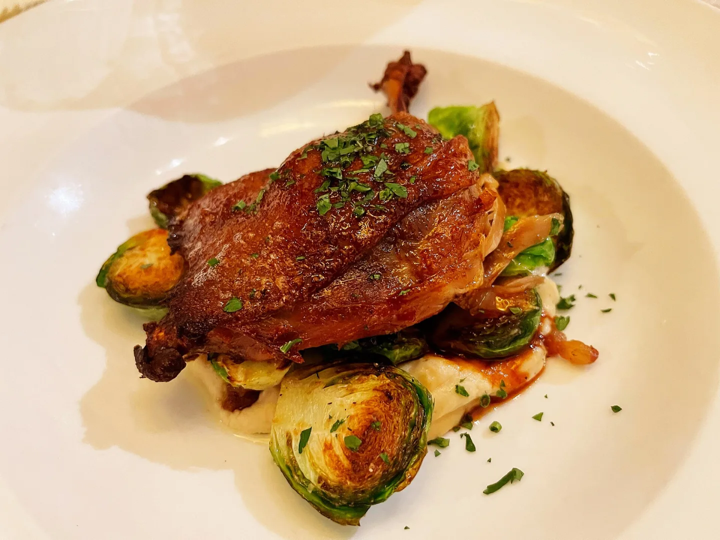 Duck confit served with potatoes.