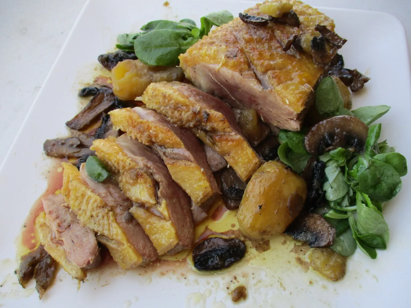 Sliced duck breast served with vegetables.