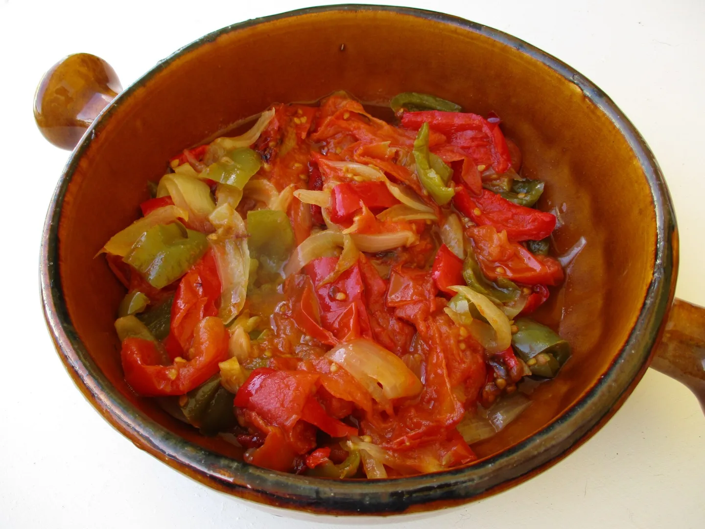 Piperade with tomatoes and peppers in a serving dish.