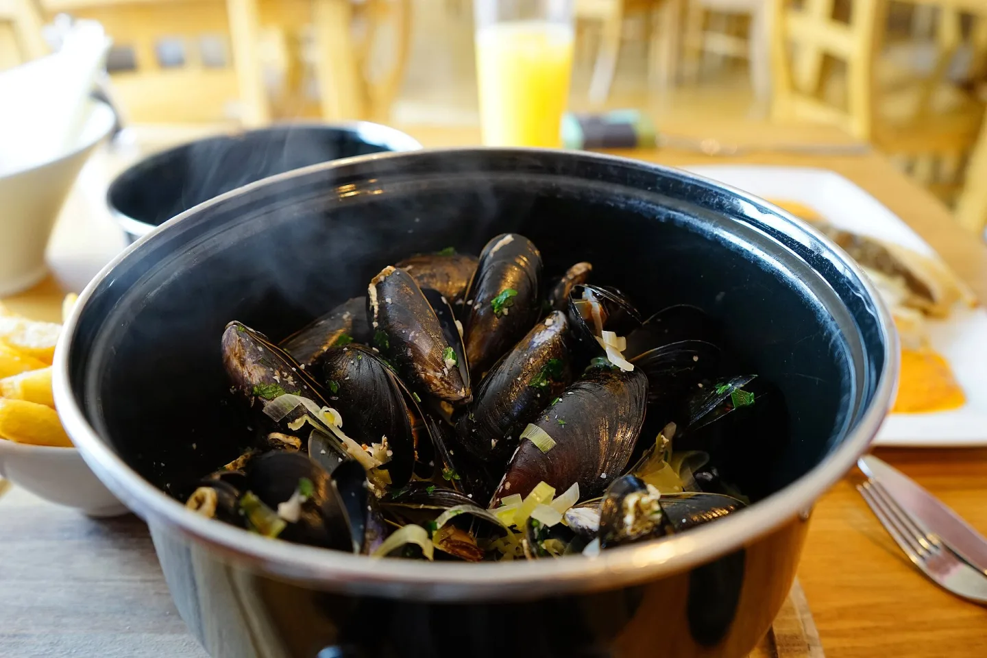Moules marinières served in a pot.
