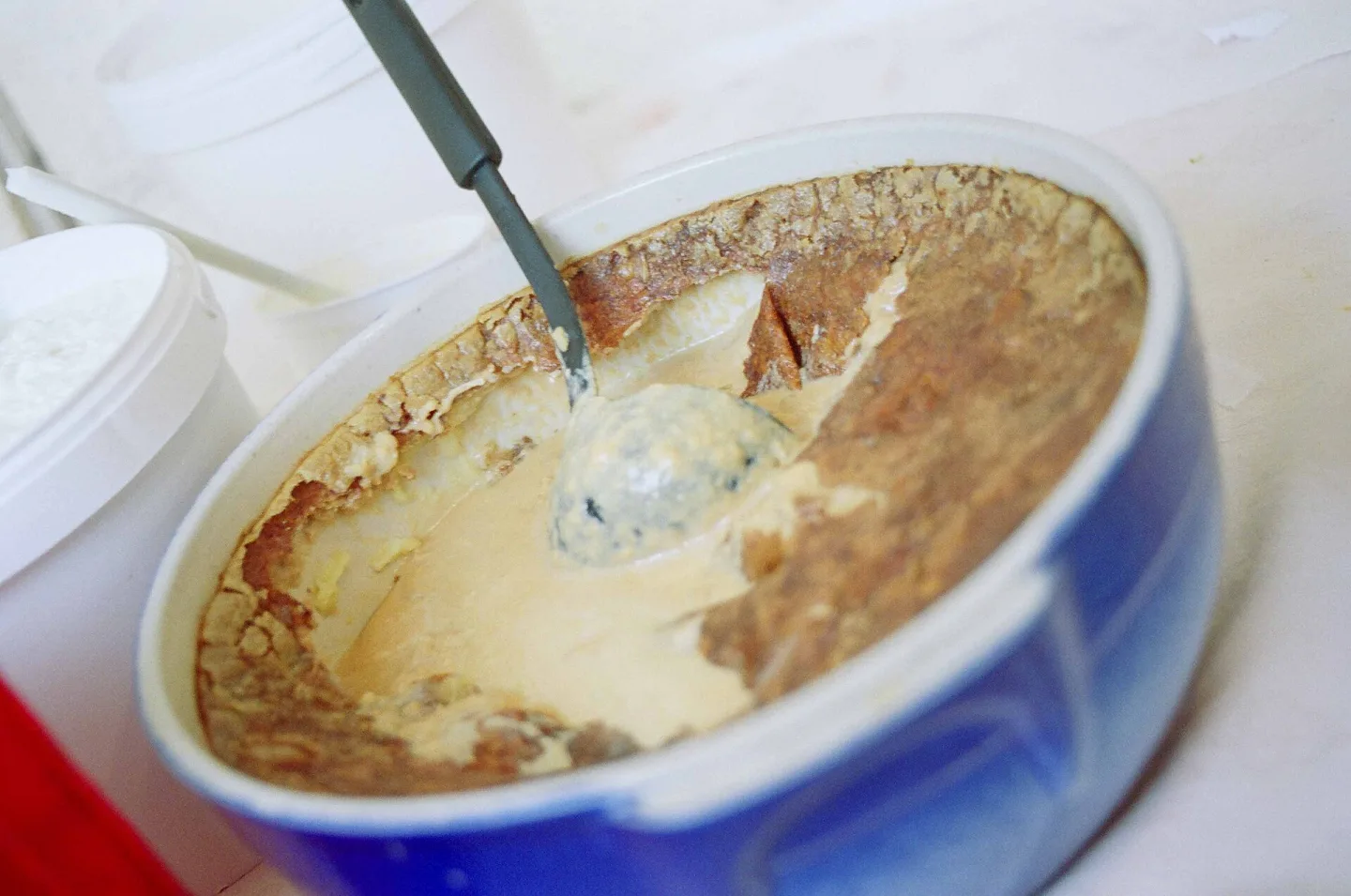 Teurgoule showing its baked surface and soft rice pudding.