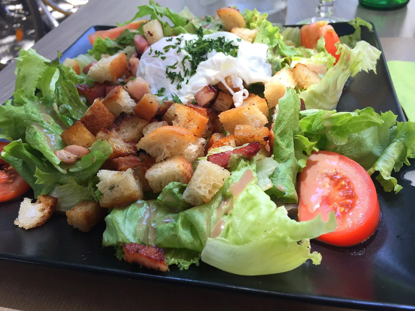 Salade lyonnaise with greens, bacon, croutons and a poached egg.