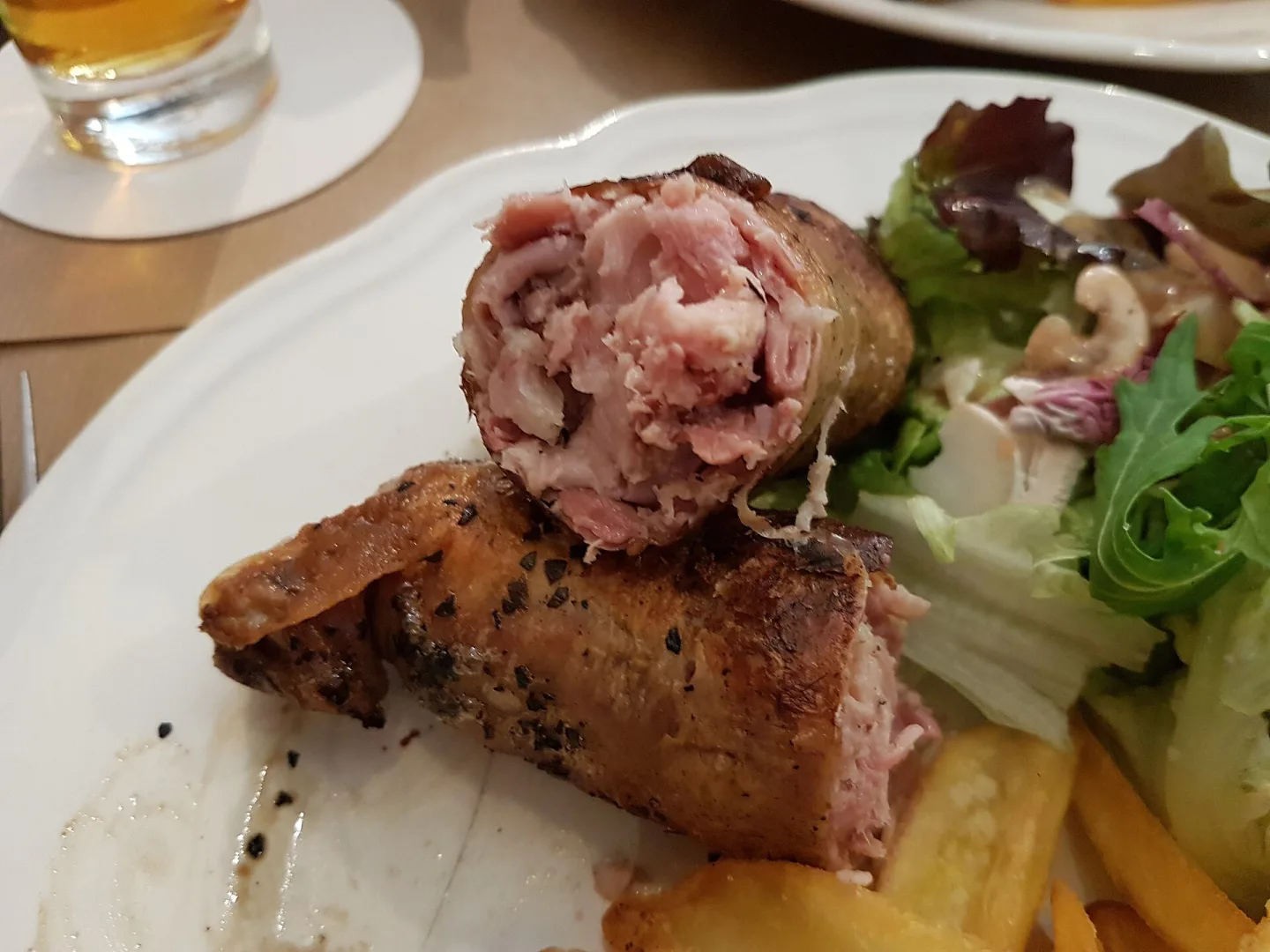 Grilled andouillette with its coarse filling visible.